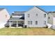 View of house and outdoor living area with BBQ grill and spacious yard at 9419 Silverdale Ln, Charlotte, NC 28269