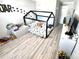 Cozy bedroom features a black canopy bed frame and dinosaur-themed decor, perfect for a space at 9419 Silverdale Ln, Charlotte, NC 28269