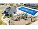 Aerial view of a community pool, playground, and pool house, offering recreational amenities at 9419 Silverdale Ln, Charlotte, NC 28269