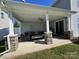 Inviting covered patio with stone pillars, comfortable seating, and ceiling fan for outdoor relaxation at 9419 Silverdale Ln, Charlotte, NC 28269
