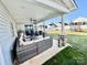 Relaxing covered patio area with stylish wicker furniture and a view of the spacious backyard at 9419 Silverdale Ln, Charlotte, NC 28269