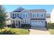 Beautiful two-story home with an attached two-car garage, well-manicured lawn, and manicured landscaping at 9419 Silverdale Ln, Charlotte, NC 28269