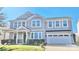 Charming two-story home with gray siding, a two-car garage, manicured lawn, and inviting front porch at 9419 Silverdale Ln, Charlotte, NC 28269