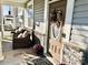Inviting front porch with seating, a decorative wreath on the door, and stone accents at 9419 Silverdale Ln, Charlotte, NC 28269