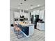 Modern open concept kitchen with an island, white cabinets, and stainless steel appliances at 9419 Silverdale Ln, Charlotte, NC 28269