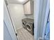 Functional laundry room with gray washer and dryer set and overhead storage cabinets at 9419 Silverdale Ln, Charlotte, NC 28269