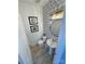 Stylish powder room with a modern vanity, decorative mirror, and patterned wallpaper at 9419 Silverdale Ln, Charlotte, NC 28269