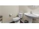 Bathroom showcasing a modern toilet and sink with a pedestal at 966 Nw Parkland Pl, Concord, NC 28027