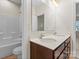 Bathroom featuring a dual sink vanity, a soaking tub, and a large mirror at 966 Nw Parkland Pl, Concord, NC 28027