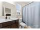 Bathroom featuring a toilet, sink, mirror, vanity, and a shower with a shower curtain at 966 Nw Parkland Pl, Concord, NC 28027
