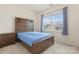Carpeted bedroom with window, bed and nightstand; bright and neutral color scheme at 966 Nw Parkland Pl, Concord, NC 28027