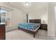 Bright bedroom with two windows, neutral walls, and dark wood bed frame at 966 Nw Parkland Pl, Concord, NC 28027