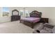 Bedroom with large windows, a king size bed, and dark wood furniture set at 966 Nw Parkland Pl, Concord, NC 28027