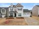 Inviting two-story home featuring a two-car garage and well-manicured landscaping at 966 Nw Parkland Pl, Concord, NC 28027