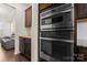 Modern stainless steel oven and microwave combination with granite countertops and wood cabinets at 966 Nw Parkland Pl, Concord, NC 28027