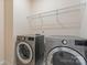 Laundry room with modern washer and dryer and wire rack shelving above at 966 Nw Parkland Pl, Concord, NC 28027