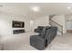 Spacious living room with plush carpeting, a TV, and a staircase to the second floor at 966 Nw Parkland Pl, Concord, NC 28027