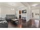Comfortable living room with hardwood floors, detailed trim, and a wall-mounted TV at 966 Nw Parkland Pl, Concord, NC 28027