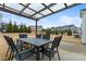Patio with a table and chairs under a pergola in a backyard setting at 966 Nw Parkland Pl, Concord, NC 28027