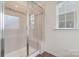 Bathroom shower with tile surround, glass door and frame, and a built in bench at 966 Nw Parkland Pl, Concord, NC 28027