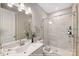 Modern bathroom features a marble-tiled shower, stylish vanity, and elegant fixtures at 9864 Quercus Ln, Huntersville, NC 28078