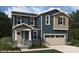 Two-story home with blue siding, stone accents, and a two-car garage at 9864 Quercus Ln, Huntersville, NC 28078