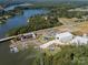 Stunning aerial view of waterfront property with marina, boat storage, and lake access, set amidst lush greenery at 1005 Willow Bank Ln, Belmont, NC 28012