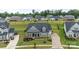 Aerial view of the gray home with well-manicured landscaping and an expansive driveway at 1005 Willow Bank Ln, Belmont, NC 28012