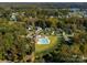 Aerial view of a luxurious community pool and surrounding homes nestled within lush greenery at 1005 Willow Bank Ln, Belmont, NC 28012