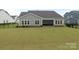 A spacious backyard with a covered outdoor seating area for relaxation and entertainment at 1005 Willow Bank Ln, Belmont, NC 28012