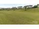 Large backyard showcasing an expansive grassy area and neighborhood views at 1005 Willow Bank Ln, Belmont, NC 28012