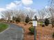 Scenic community path surrounded by trees and landscaping, with clear signage for trail and pond rules at 1005 Willow Bank Ln, Belmont, NC 28012