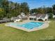 Aerial view of a sparkling community pool surrounded by well-maintained landscaping and recreational spaces at 1005 Willow Bank Ln, Belmont, NC 28012