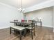 Elegant dining room featuring a modern chandelier and stylish seating area with hardwood floors at 1005 Willow Bank Ln, Belmont, NC 28012