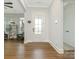 Bright foyer featuring hardwood floors, a white door, and an open view into the living area at 1005 Willow Bank Ln, Belmont, NC 28012