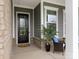 Close-up view of front door and covered entryway with decorated chairs at 1005 Willow Bank Ln, Belmont, NC 28012