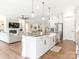 Open-concept kitchen with an island and sink, seamlessly connected to the living and dining areas at 1005 Willow Bank Ln, Belmont, NC 28012