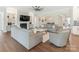 Bright, open living room with stylish sofas, fireplace, and views into the dining and kitchen areas at 1005 Willow Bank Ln, Belmont, NC 28012