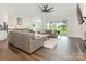 Spacious living room with modern sofas, a ceiling fan and sliding glass doors leading to the backyard at 1005 Willow Bank Ln, Belmont, NC 28012