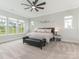 Features a bed, bench, ceiling fan, and natural light at 1005 Willow Bank Ln, Belmont, NC 28012
