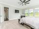 Bright main bedroom featuring a ceiling fan, large windows and plush carpet at 1005 Willow Bank Ln, Belmont, NC 28012