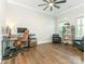 Spacious office with dark wood floors, a ceiling fan, and plenty of natural light at 1005 Willow Bank Ln, Belmont, NC 28012