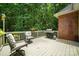 Relaxing back deck with a grill, seating, and a beautiful view of the surrounding woods at 10501 Olde Irongate Ln, Mint Hill, NC 28227