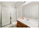 Bathroom with white vanity, frameless shower, and neutral tile flooring at 10501 Olde Irongate Ln, Mint Hill, NC 28227
