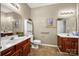 Bathroom with wood vanities, neutral paint, and sinks, and tile floors at 10501 Olde Irongate Ln, Mint Hill, NC 28227
