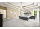 An expansive bedroom features a large bed, dresser, and ensuite bathroom in a neutral palette at 10501 Olde Irongate Ln, Mint Hill, NC 28227