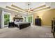 Beautiful bedroom with a tray ceiling, large windows, and neutral décor for a relaxing retreat at 10501 Olde Irongate Ln, Mint Hill, NC 28227