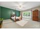 Main bedroom with a four-poster bed, wood accent wall, and a large window at 10501 Olde Irongate Ln, Mint Hill, NC 28227