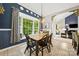 Sunlit dining room with a large bay window, stylish curtains, and a view into the living area at 10501 Olde Irongate Ln, Mint Hill, NC 28227