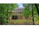 Rear exterior view of a brick home with a deck, bay window, and fenced-in backyard at 10501 Olde Irongate Ln, Mint Hill, NC 28227